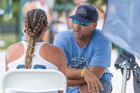Volunteer assistant coach Doug Wright talks to Lauren Galinis