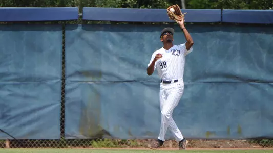 Justin Holmes catches a fly ball.