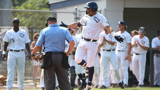 Abraham Sequera jumps on home plate after a home run.