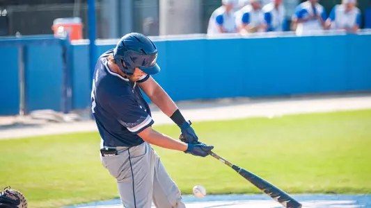 Caleb Stafford making contact with a pitch.