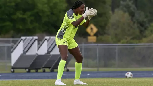 Mercedes Sapp claps her hands while standing in goal