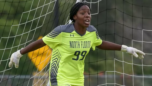 Mercedes_Sapp stands in front of the net with her arms spread wide