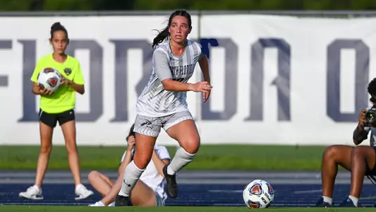 Kayla Bond dribbles the ball down the sideline