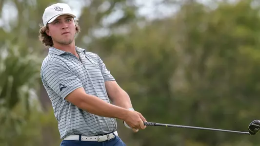 Grant Sutliff swings the golf club and watches the shot sail away