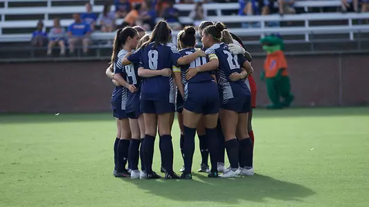 Women's soccer starters huddle a midfield prior to match at Florida