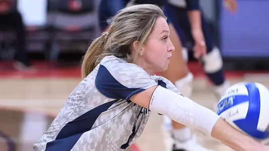 Logan O'Brien digs a ball