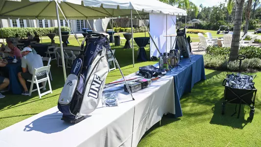 Table decorated with golf bag and other items at the 2021 Fore Scholarship Golf Tournament