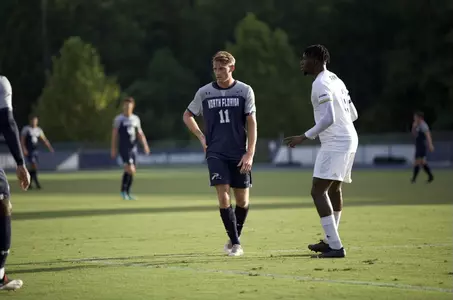 Bryson Smith standing next to FIU player