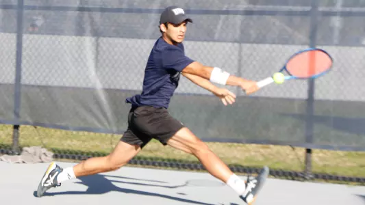Breno on the reach for a one-handed backhand