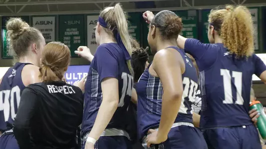 UNF women's basketball team huddle at FGCU