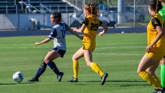 Kayla Bond kicking the ball forward