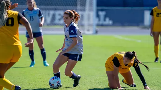 Gabby Daly dribbling by an opponent