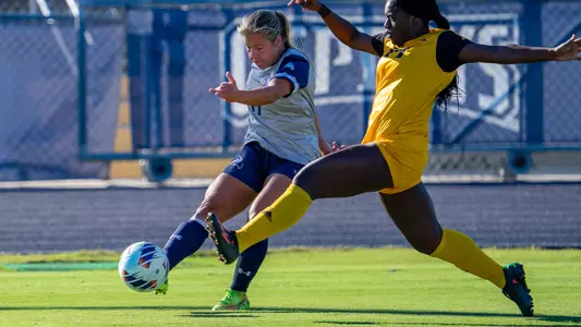 Allie Fekany kicking the ball ahead