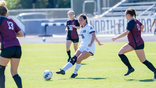 Kayla Bond kicking the ball forward