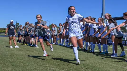 Mia Sadler high fiving the team