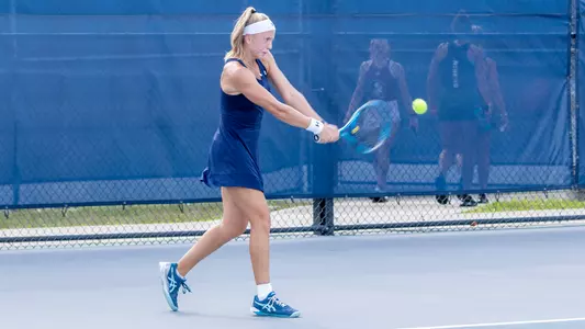 Mgean Forster hitting a backhand