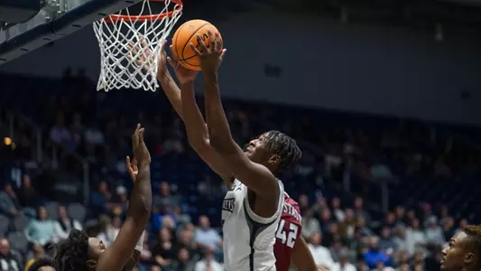 Dorian James driving for a layup