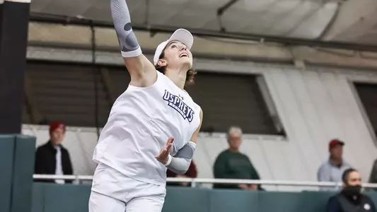 UNF Women's Tennis action shot with Kit Gulihur about to overhead smash the ball.