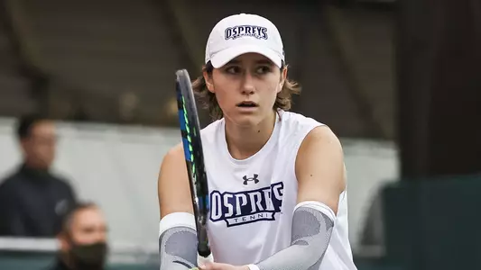 UNF Women's Tennis action shot with Kit Gulihur focused on the point.