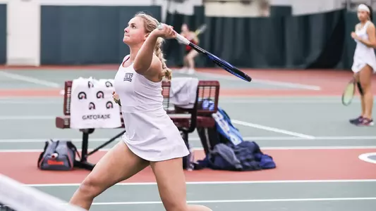 UNF Women's Tennis action shot with Summer Yardley about to overhead smash the ball.