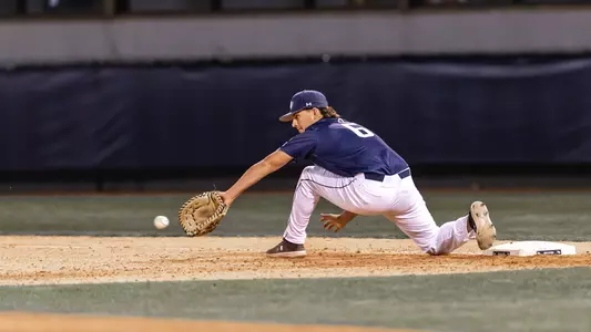 Caleb Stafford reaching out for a throw to first base