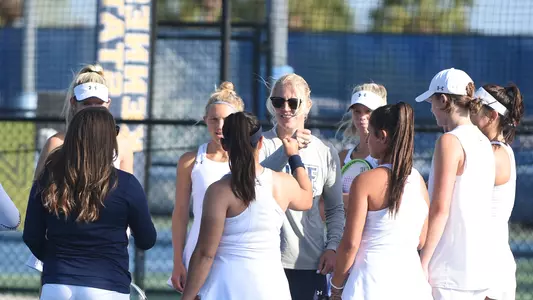UNF women's tennis team photo in the huddle