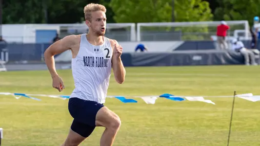 Ryan Thomas running hurdles at UNF Invite