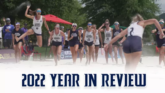2022 year in review beach volleyball with a picture of the team celebrating