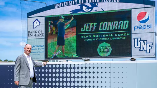 Jeff Conrad pointing to a graphic on the videoboard