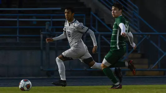 Gio Abreu dribbling past JU defender