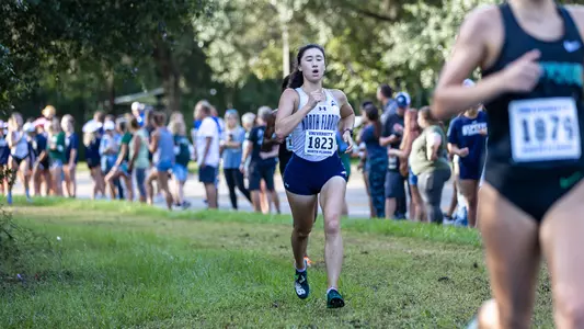 Emma Forde running in the grass in the 5k