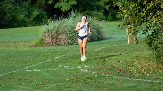 Emma Milson running on the grass