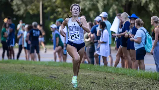 Emma Millson running on the grass in the 5k
