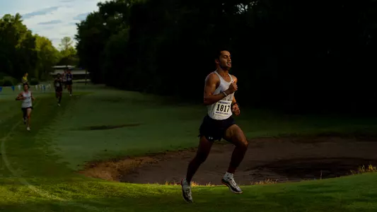 Kameron Wallizada running on the grass