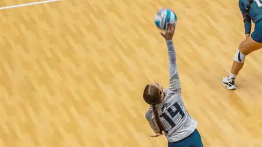 Maymie Guthrie serving the ball