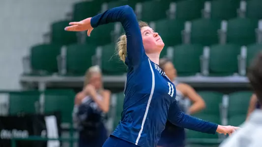 Savannah Cook serving the ball