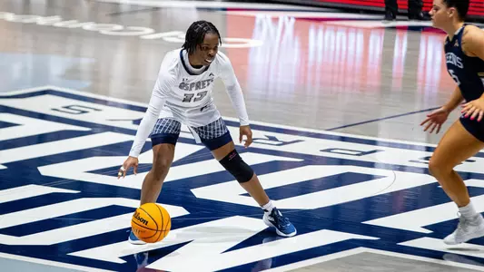Kaila Rougier dribbling against Queens