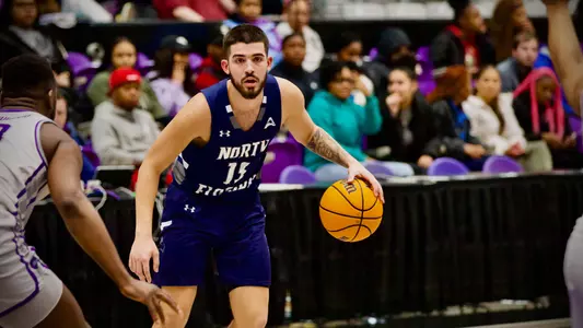 Jose Placer dribbling the ball up the court