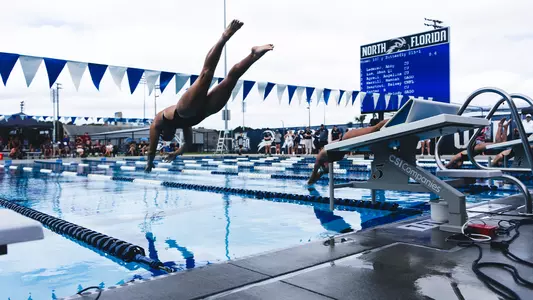 Kelsey Swartout diving into the UNF Competition Pool off the block