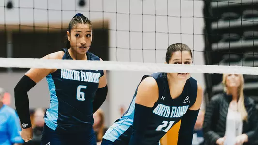 Janelly Ceopa and Kyla Solis at the net during a match