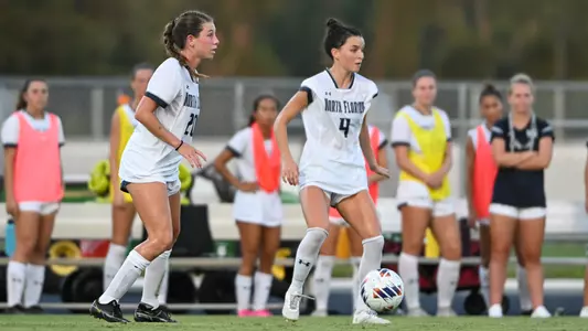 Amanda Hartmann and Averi Walraven dribbling up the field