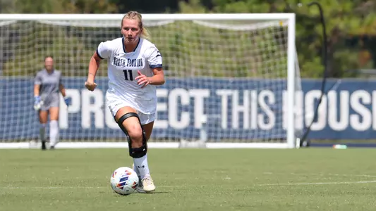 Sophia Goetz dribbling the ball up the field