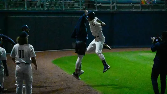 Alex Lodise jumping up to celebrate a home run