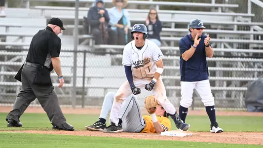 Alex Lodise celebrating at third base