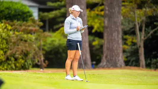 Wyndom Burnett going through routine before golf shot