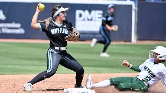 Maegan Calandra throwing to first
