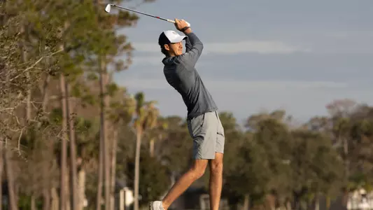 Nick Gabrelcik hitting iron shot on the fairway