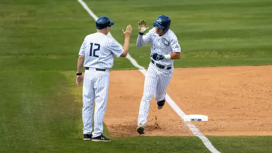 Alex Lodise rounding third following a home run