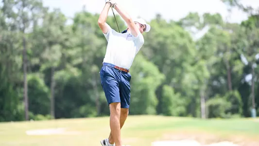 Robbie Higgins hitting shot on golf course