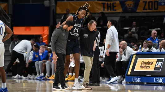 Fred Burnett helping on the court with Jadyn Parker